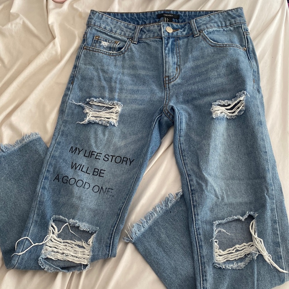 denim mom jeans with a quote on them